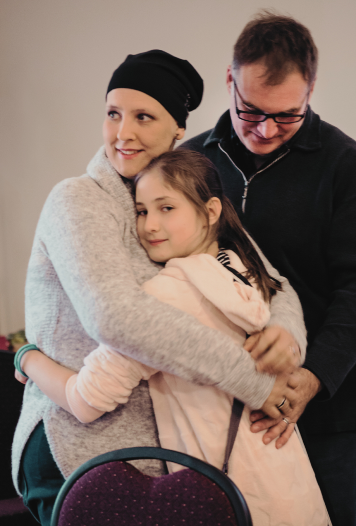 family of Cancer Patient hugging
